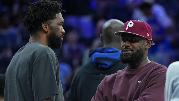 Joel Embiid #21 of the Philadelphia 76ers talks to LeBron James #23.