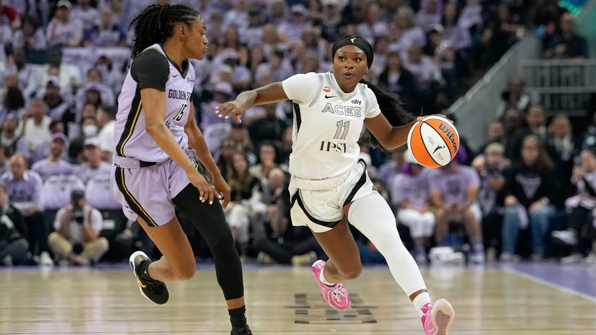 Dana Evans #11 of the Las Vegas Aces dribbling up court is defended by Tiffany Hayes #15 of the Golden State Valkyries (Source: Thearon W. Henderson/Getty Images)