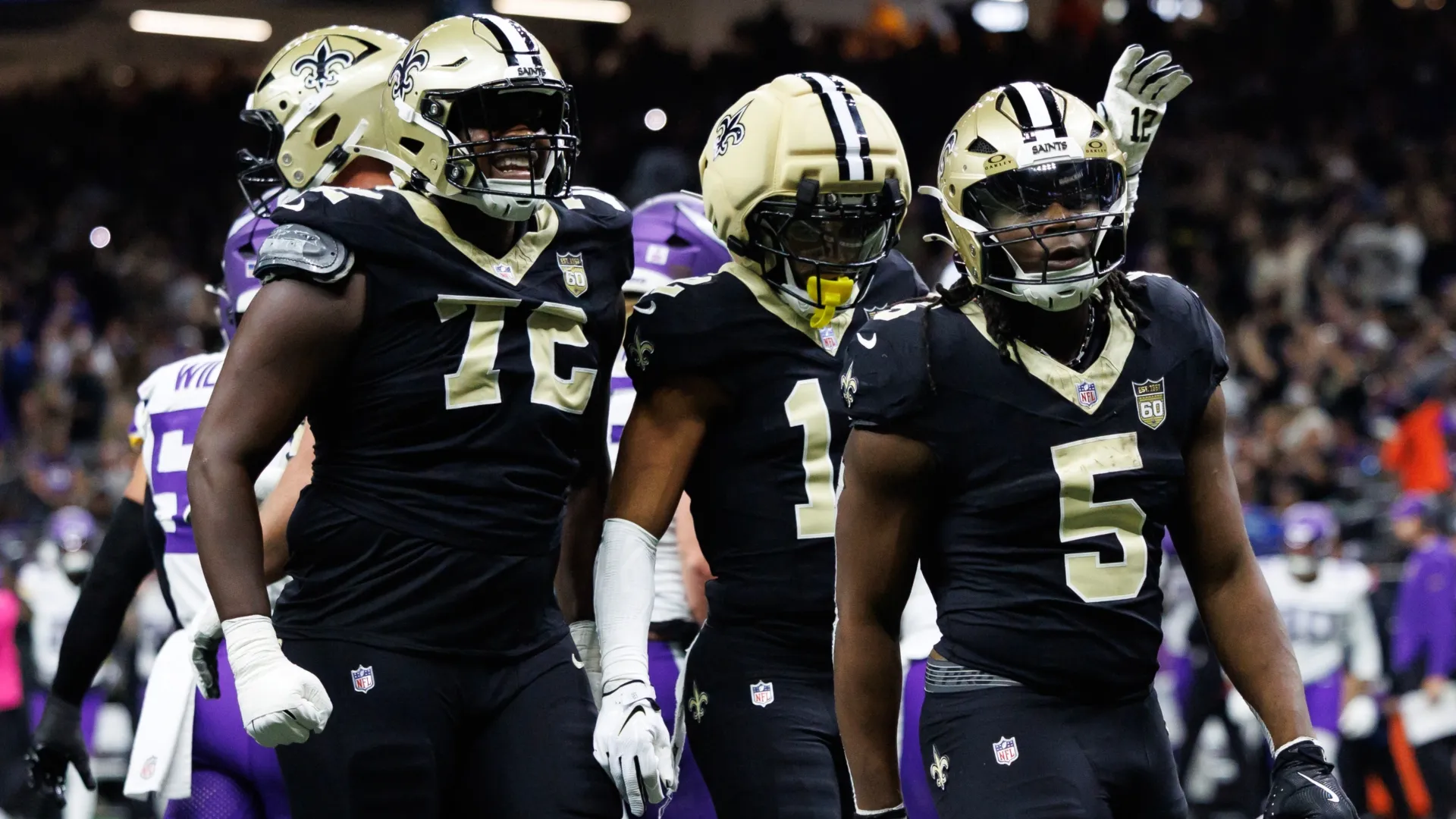 Asim Richards #72, Chris Olave #12 and Kendre Miller #5 of the New Orleans Saints (Source: Morgan Simmons/Getty Images)