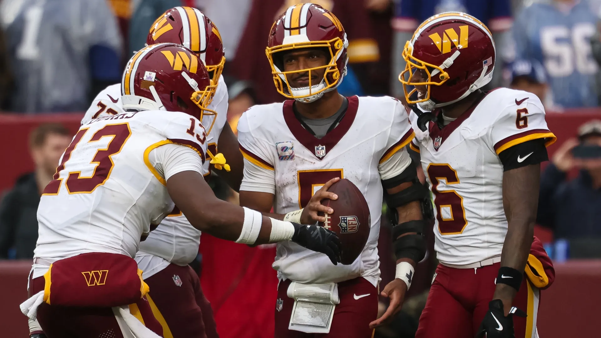 Jayden Daniels #5 of the Washington Commanders celebrates with teammates (Source: Scott Taetsch/Getty Images)