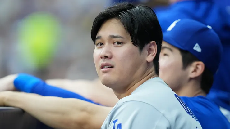 Shohei Ohtani #17 of the Los Angeles Dodgers looks on from the dugout.