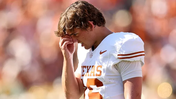 Arch Manning #16 of the Texas Longhorns stands on the sideline.