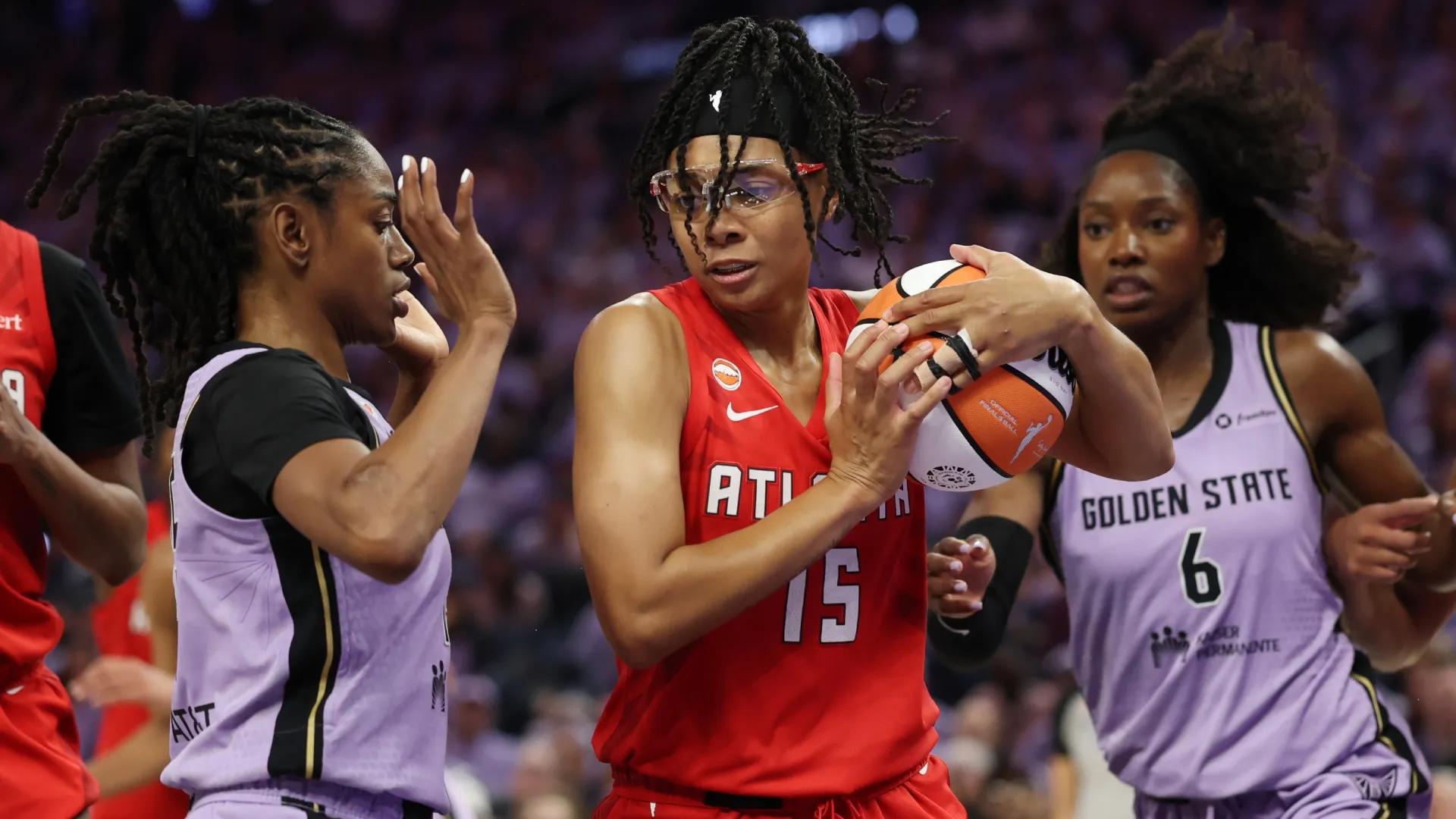 Allisha Gray #15 of the Dream controls the ball between Tiffany Hayes #15 and Kaila Charles #6 of the Valkyries (Source: Ezra Shaw/Getty Images)