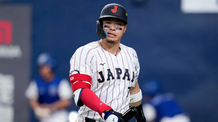 Teruaki Sato #7 of Japan reacts after strikes out in the second inning.