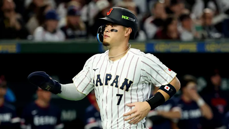 Teruaki Sato #7 of Team Japan scores a run.