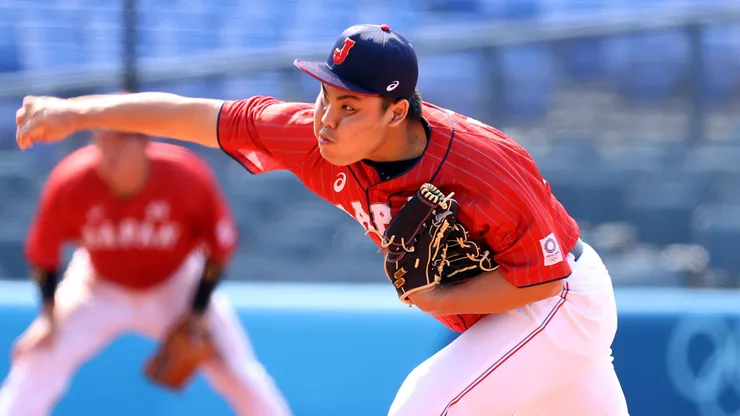 Relief pitcher Kaima Taira #61 of Team Japan pitches.