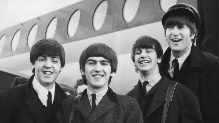 392279 03: FILE PHOTO: The Beatles, left to right, Paul McCartney, George Harrison, Ringo Starr and John Lennon (1940 - 1980) arrive at London Airport February 6, 1964, after a trip to Paris. Conflicting reports were released July 23, 2001 regarding Beatle George Harrison"s battle with cancer. Music producer Sir George Martin was quoted as saying that Harrison expects to die soon from his illnesses. The 58-year-old musician underwent treatment for a brain tumor at a clinic in Switzerland, and had surgery earlier this year for lung cancer. (Photo by Getty Images)
