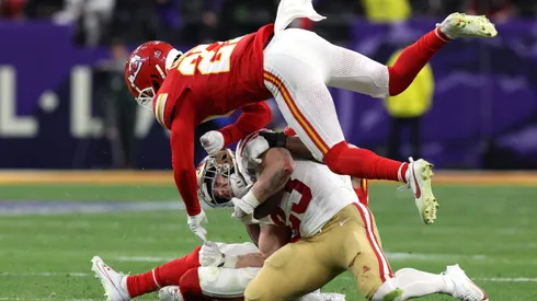 LAS VEGAS, NEVADA - FEBRUARY 11: Christian McCaffrey #23 of the San Francisco 49ers is hit by Justin Reid #20 and Chamarri Conner #27 of the Kansas City Chiefs during the second quarter during Super Bowl LVIII at Allegiant Stadium on February 11, 2024 in Las Vegas, Nevada. (Photo by Jamie Squire/Getty Images)
