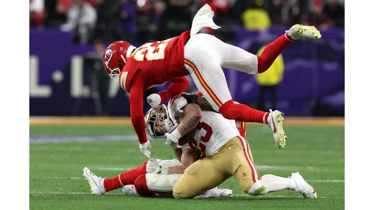 LAS VEGAS, NEVADA - FEBRUARY 11: Christian McCaffrey #23 of the San Francisco 49ers is hit by Justin Reid #20 and Chamarri Conner #27 of the Kansas City Chiefs during the second quarter during Super Bowl LVIII at Allegiant Stadium on February 11, 2024 in Las Vegas, Nevada. (Photo by Jamie Squire/Getty Images)