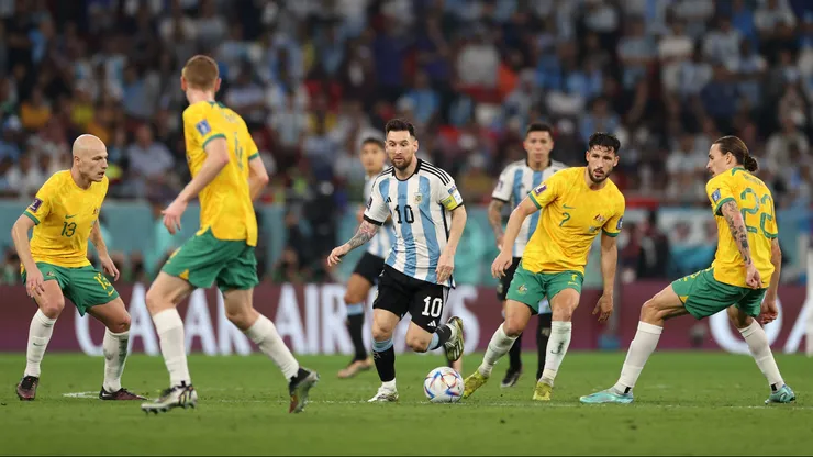 DOHA, QATAR - DECEMBER 03: Lionel Messi of Argentina tracked by Aaron Mooy (l) Mathew Leckie (2r) and Jackson Irvine (r) of Australia during the FIFA World Cup Qatar 2022 Round of 16 match between Argentina and Australia at Ahmad Bin Ali Stadium on December 03, 2022 in Doha, Qatar. (Photo by Michael Steele/Getty Images)