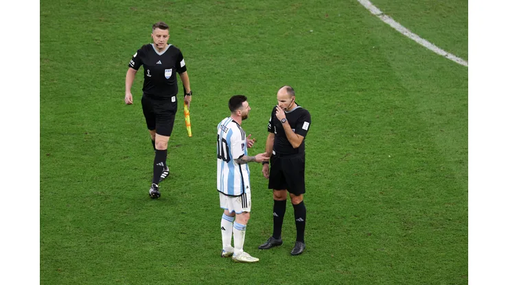 LUSAIL CITY, QATAR - DECEMBER 09: Referee Antonio Mateu speaks to Lionel Messi of Argentina as they leave the pitch for half time during the FIFA World Cup Qatar 2022 quarter final match between Netherlands and Argentina at Lusail Stadium on December 09, 2022 in Lusail City, Qatar. (Photo by Elsa/Getty Images)