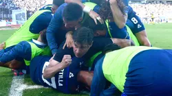 El Cacique Medina en el medio de la montaña de jugadores de Talleres celebrando el gol de Bruno Barticciotto ante Gimnasia y Esgrima La Plata.