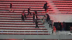 AVELLANEDA, ARGENTINA - AUGUST 20: Independiente and Universidad de Chile fans clash during the CONMEBOL Sudamericana 2025 round of 16 second leg match between Independiente and Universidad de Chile at Estadio Libertadores de América on August 20, 2025 in Avellaneda, Argentina. The game was suspended during the second half after fans of both teams started a fight in the stands. As of today, the authorities report 19 people taken to the hospital with over 90 arrested by the police. (Photo by Ruben Paredes/Getty Images)