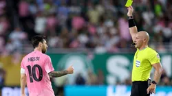 Lionel Messi recibiendo una tarjeta amarilla.