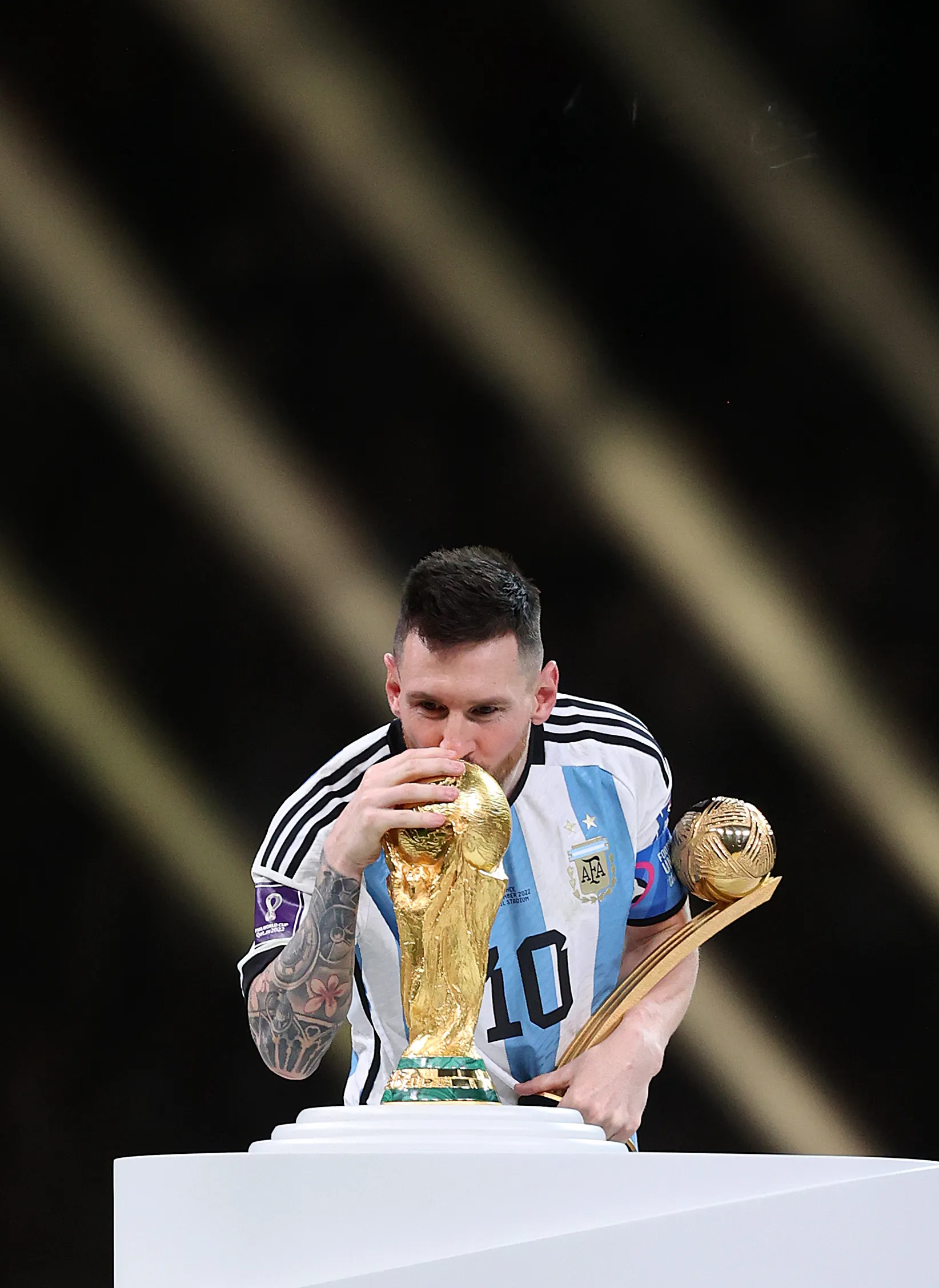Lionel Messi besa la Copa del Mundo, junto al premio a mejor jugador del certamen. (Getty).