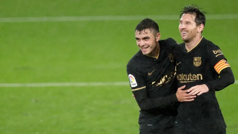 Pedri y Lionel Messi en el FC Barcelona.