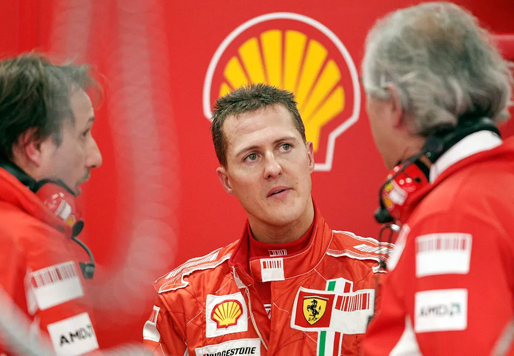 BARCELONA, SPAIN – NOVEMBER 13: Seven times world champion Michael Schumacher of Germany talks with engineers after test-drives for Ferrari during Formula One testing at the Circuit de Catalunya, on November 13, 2007 in Barcelona, Spain. (Photo by Jasper Juinen/Getty Images)