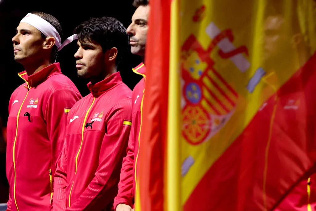 MALAGA, SPAIN – NOVEMBER 19: Rafael Nadal and Carlos Alcaraz of Spain line up for the national anthems ahead of the singles match between Rafael Nadal of Spain and Botic van de Zandschulp of Netherlands in the quarterfinal tie between Netherlands and Spain during the Davis Cup Finals at Palacio de Deportes Jose Maria Martin Carpena on November 19, 2024 in Malaga, Spain. (Photo by Clive Brunskill/Getty Images for ITF)