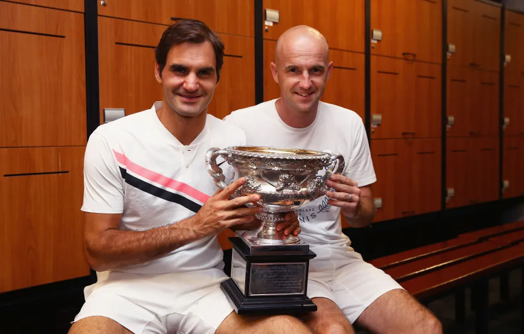 MELBOURNE, AUSTRALIA – JANUARY 28:  Roger Federer of Switzerland and coach Ivan Ljubicic pose with the Norman Brookes Challenge Cup in the players locker room after winning the Men’s Singles Final against Marin Cilic of Croatia on day 14 of the 2018 Australian Open at Melbourne Park on January 28, 2018 in Melbourne, Australia.  (Photo by Clive Brunskill/Getty Images)