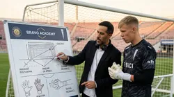 Claudio Bravo le explica con peras y manzanas a Bernedo cómo debe pararse en el arco (Foto creada con IA)