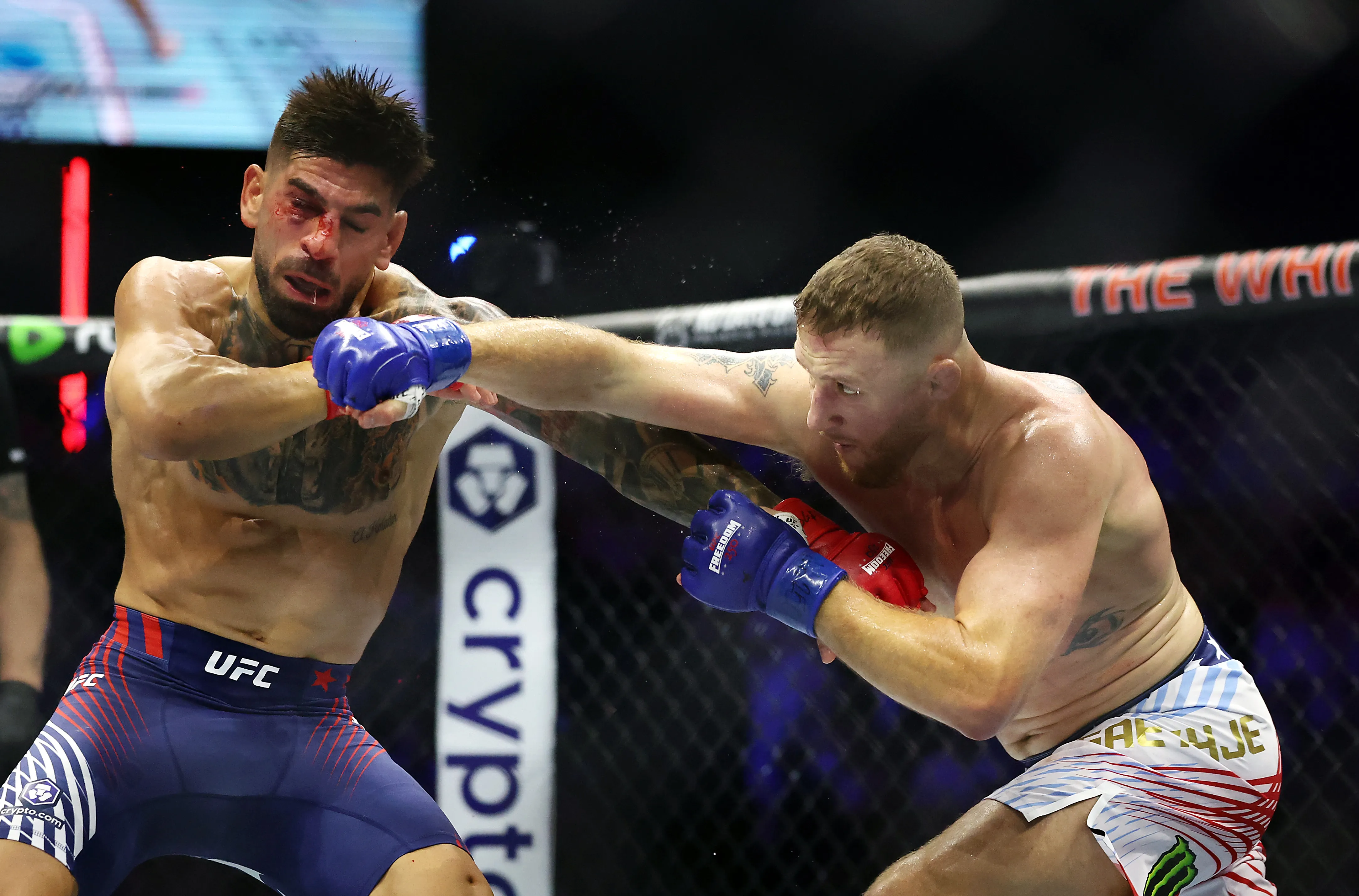 WASHINGTON, DC – JUNE 14: Ilia Topuria of Georgia and Justin Gaethje of the United States exchange punches in the UFC Lightweight Championship bout during UFC Freedom 250 at the White House on June 14, 2026 in Washington, DC. (Photo by Chris Graythen/Getty Images)