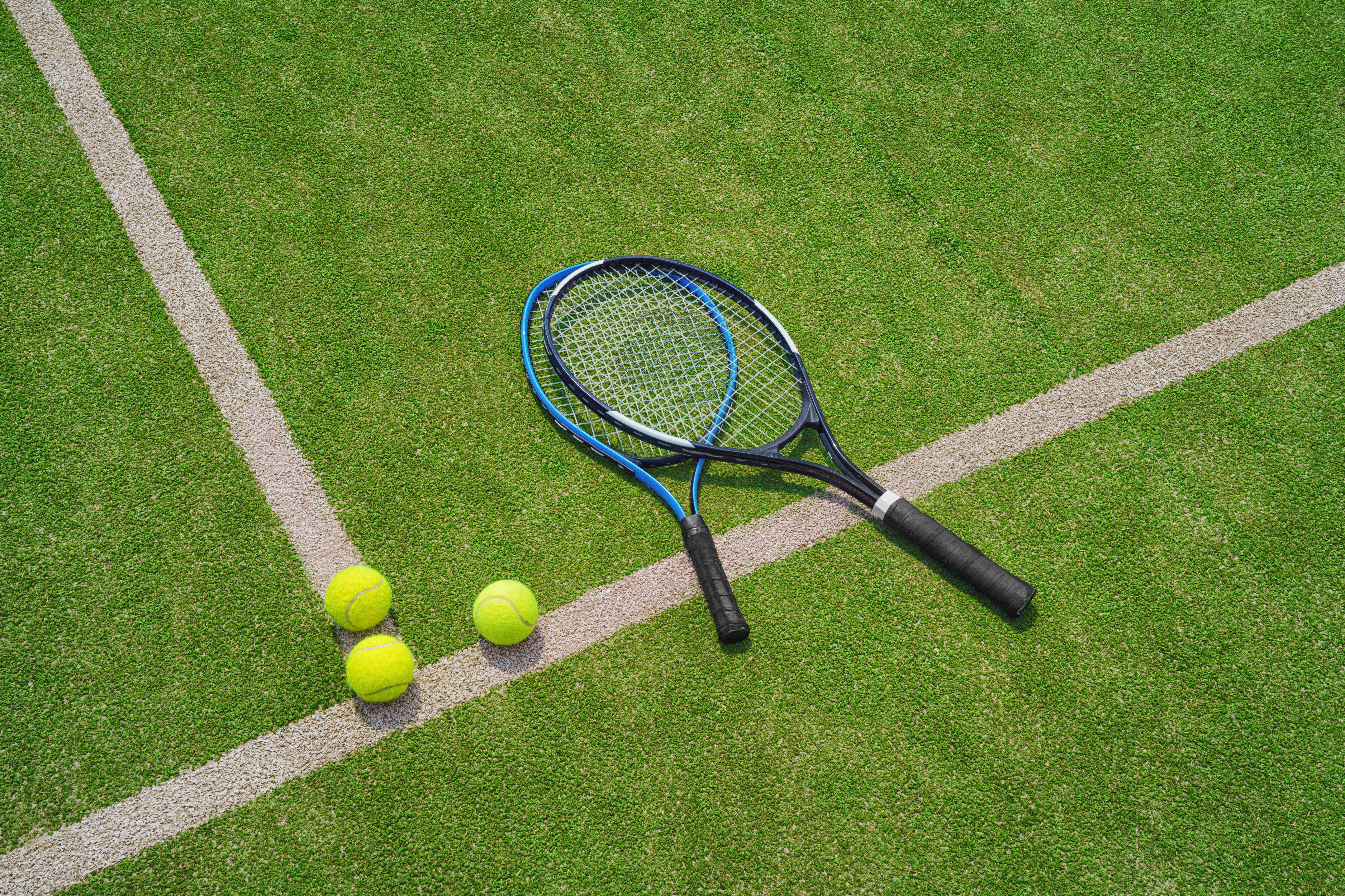 Dos raquetas de tenis sobre pasto verde
