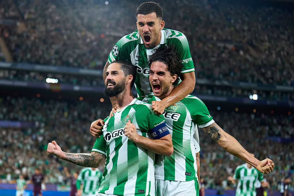 SEVILLE, SPAIN – OCTOBER 14: Isco of Real Betis celebrates after scoring his team’s third goal with Marc Bartra and Dani Ceballos during the UEFA Champions League 2026/27 League Phase MD2 match between Real Betis Balompie and FC Porto at Estadio de La Cartuja on October 14, 2026 in Seville, Spain. (Photo by Angel Martinez/Getty Images)