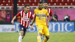 ZAPOPAN, MEXICO - SEPTEMBER 13: Jesús Angulo of Chivas fights for the ball with Rafael De Souza of Tigres during the 9th round match between Chivas and Tigres UANL as part of the Torneo Apertura 2022 Liga MX at Akron Stadium on September 13, 2022 in Zapopan, Mexico. (Photo by Refugio Ruiz/Getty Images)