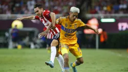 ZAPOPAN, MEXICO - SEPTEMBER 13: Jesús Angulo of Chivas fights for the ball with Raymundo Fulgencio of Tigres during the 9th round match between Chivas and Tigres UANL as part of the Torneo Apertura 2022 Liga MX at Akron Stadium on September 13, 2022 in Zapopan, Mexico. (Photo by Refugio Ruiz/Getty Images)