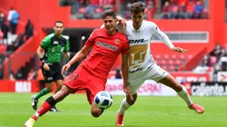 Juan Dinenno en duelo con Haret Ortega, defensa del Toluca.