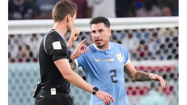 (221202) — AL WAKRAH, Dec. 2, 2022 — Jose Maria Gimenez (R) of Uruguay argues with referee Daniel Siebert after the Gr