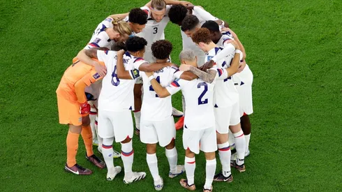 DOHA, QATAR - NOVEMBER 21: Team United States huddle before the opening kickoff against Wales during the FIFA World Cup Qatar 2022 Group B match between USA and Wales at Ahmad Bin Ali Stadium on November 21, 2022 in Doha, Qatar. (Photo by Elsa/Getty Images)-Not Released (NR) Images cannot be used in books or individually in the form of mobile alert services or downloads without prior approval from FIFA