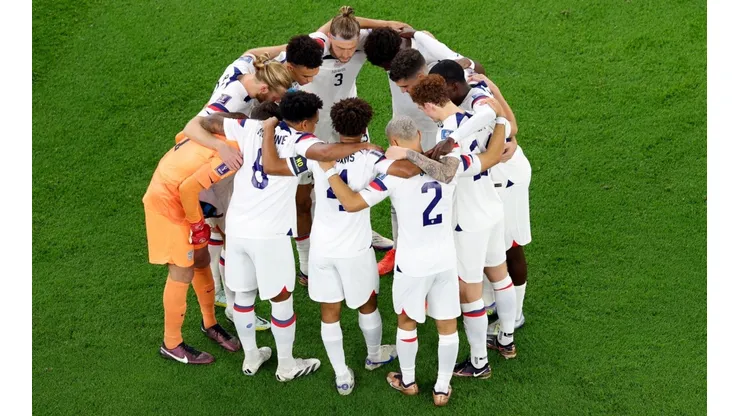 DOHA, QATAR - NOVEMBER 21: Team United States huddle before the opening kickoff against Wales during the FIFA World Cup Qatar 2022 Group B match between USA and Wales at Ahmad Bin Ali Stadium on November 21, 2022 in Doha, Qatar. (Photo by Elsa/Getty Images)-Not Released (NR) Images cannot be used in books or individually in the form of mobile alert services or downloads without prior approval from FIFA
