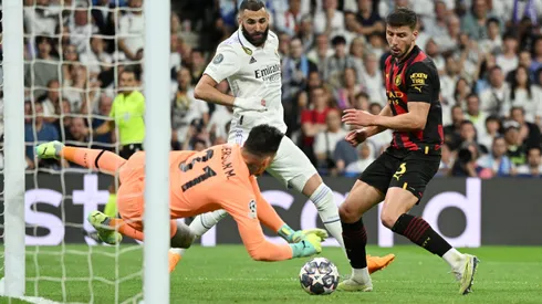 MADRID, SPAIN - MAY 09: Ederson of Manchester City makes a save from Karim Benzema of Real Madrid during the UEFA Champions League semi-final first leg match between Real Madrid and Manchester City FC at Estadio Santiago Bernabeu on May 09, 2023 in Madrid, Spain. (Photo by David Ramos/Getty Images)