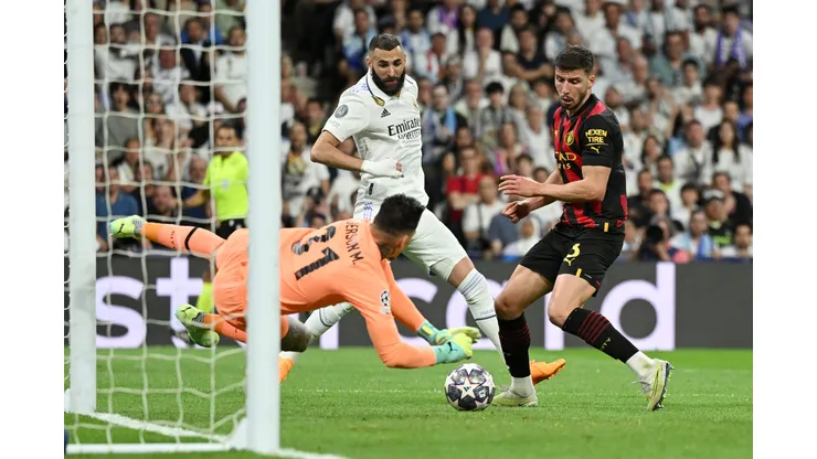 MADRID, SPAIN - MAY 09: Ederson of Manchester City makes a save from Karim Benzema of Real Madrid during the UEFA Champions League semi-final first leg match between Real Madrid and Manchester City FC at Estadio Santiago Bernabeu on May 09, 2023 in Madrid, Spain. (Photo by David Ramos/Getty Images)