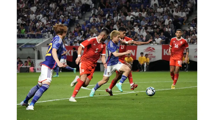 SUITA, JAPAN - JUNE 20: Ritsu Doan of Japan competes for the ball against Wilder Cartagena and Carlos Zambrano of Peru during the international friendly match between Japan and Peru at Panasonic Stadium Suita on June 20, 2023 in Suita, Osaka, Japan. (Photo by Koji Watanabe/Getty Images)