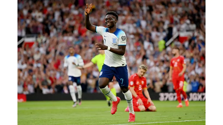 MANCHESTER, ENGLAND - JUNE 19: Bukayo Saka of England celebrates after scoring the team's fifth goal and his third during the UEFA EURO 2024 qualifying round group C match between England and North Macedonia at Old Trafford on June 19, 2023 in Manchester, England. (Photo by Justin Setterfield/Getty Images)