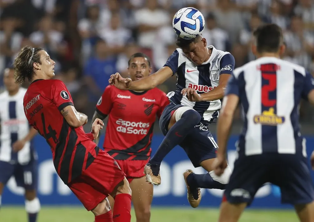 LIMA, PERU – APRIL 04: Jesus Castillo of Alianza Lima heads the ball against Agustin Canobbio of Athletico Paranaense during a Copa CONMEBOL Libertadores group G match between Alianza Lima and Athletico Paranaense at Estadio Alejandro Villanueva on April 4, 2023 in Lima, Peru. (Photo by Daniel Apuy/Getty Images)