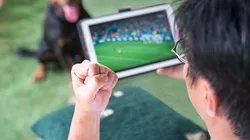 Man with fist up while watching soccer sports game on digital tablet. Live stream or sports online concept. Contributor: Sinseeho Lifestyle / Alamy Stock Photo Image ID: 2K8WPP8