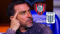 Pablo Guede mirando los escudos de San Lorenzo y Alianza Lima.