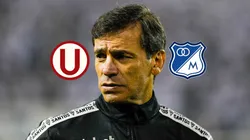 El técnico Fabián Bustos al lado de los escudos de Universitario y Millonarios.