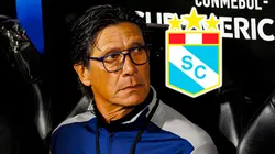 El técnico Ángel Comizzo y el escudo de Sporting Cristal.