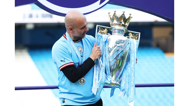 MANCHESTER, ENGLAND - MAY 21: Pep Guardiola, Manager of Manchester City, celebrates with the Premier League trophy following after the Premier League match between Manchester City and Chelsea FC at Etihad Stadium on May 21, 2023 in Manchester, England. (Photo by Catherine Ivill/Getty Images)