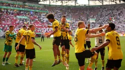 AUGSBURG, GERMANY - MAY 21: Karim Adeyemi and Mats Hummels of Borussia Dortmund celebrate after the team's victory in the Bundesliga match between FC Augsburg and Borussia Dortmund at WWK-Arena on May 21, 2023 in Augsburg, Germany. (Photo by Adam Pretty/Getty Images)