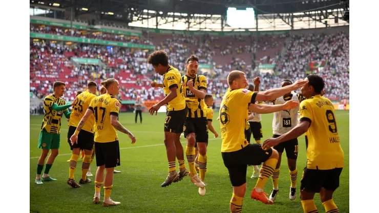 AUGSBURG, GERMANY - MAY 21: Karim Adeyemi and Mats Hummels of Borussia Dortmund celebrate after the team's victory in the Bundesliga match between FC Augsburg and Borussia Dortmund at WWK-Arena on May 21, 2023 in Augsburg, Germany. (Photo by Adam Pretty/Getty Images)