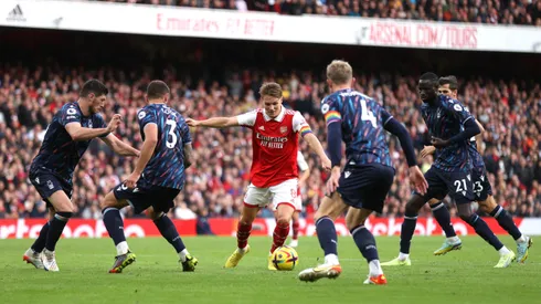 LONDON, ENGLAND – OCTOBER 30: Martin Odegaard is surrounded by Nottingham Forest players before scoring his sides fifth goal during the Premier League match between Arsenal FC and Nottingham Forest at Emirates Stadium on October 30, 2022 in London, England. (Photo by Alex Pantling/Getty Images)