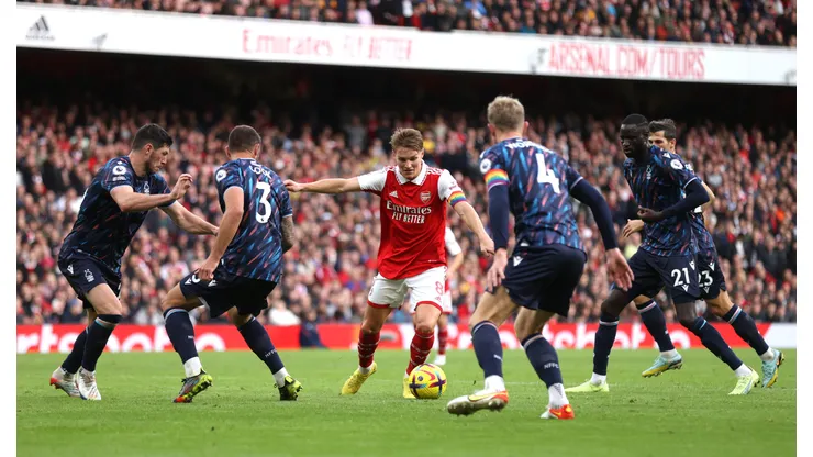 LONDON, ENGLAND - OCTOBER 30: Martin Odegaard is surrounded by Nottingham Forest players before scoring his sides fifth goal during the Premier League match between Arsenal FC and Nottingham Forest at Emirates Stadium on October 30, 2022 in London, England. (Photo by Alex Pantling/Getty Images)