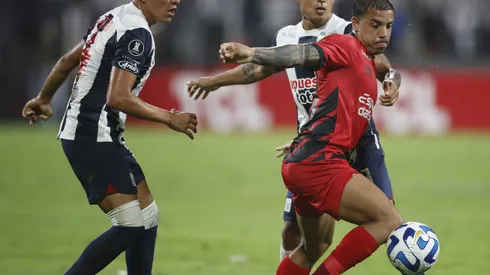 LIMA, PERU - APRIL 04: Miguel Terans of Athletico Paranaense fights for the ball with Ricardo Lagos of Alianza Lima and Jesus Castillo of Alianza Lima during a Copa CONMEBOL Libertadores group G match between Alianza Lima and Athletico Paranaense at Estadio Alejandro Villanueva on April 4, 2023 in Lima, Peru. (Photo by Daniel Apuy/Getty Images)