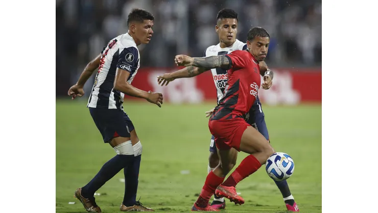 LIMA, PERU - APRIL 04: Miguel Terans of Athletico Paranaense fights for the ball with Ricardo Lagos of Alianza Lima and Jesus Castillo of Alianza Lima during a Copa CONMEBOL Libertadores group G match between Alianza Lima and Athletico Paranaense at Estadio Alejandro Villanueva on April 4, 2023 in Lima, Peru. (Photo by Daniel Apuy/Getty Images)