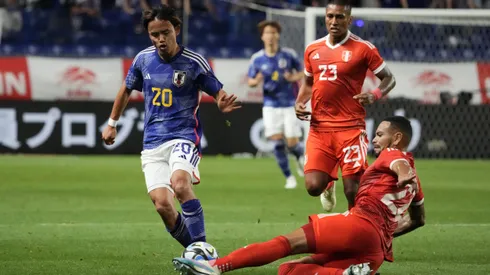 SUITA, JAPAN - JUNE 20: Takefusa Kubo of Japan is tackled by Alexander Callens of Peru during the international friendly match between Japan and Peru at Panasonic Stadium Suita on June 20, 2023 in Suita, Osaka, Japan. (Photo by Koji Watanabe/Getty Images)